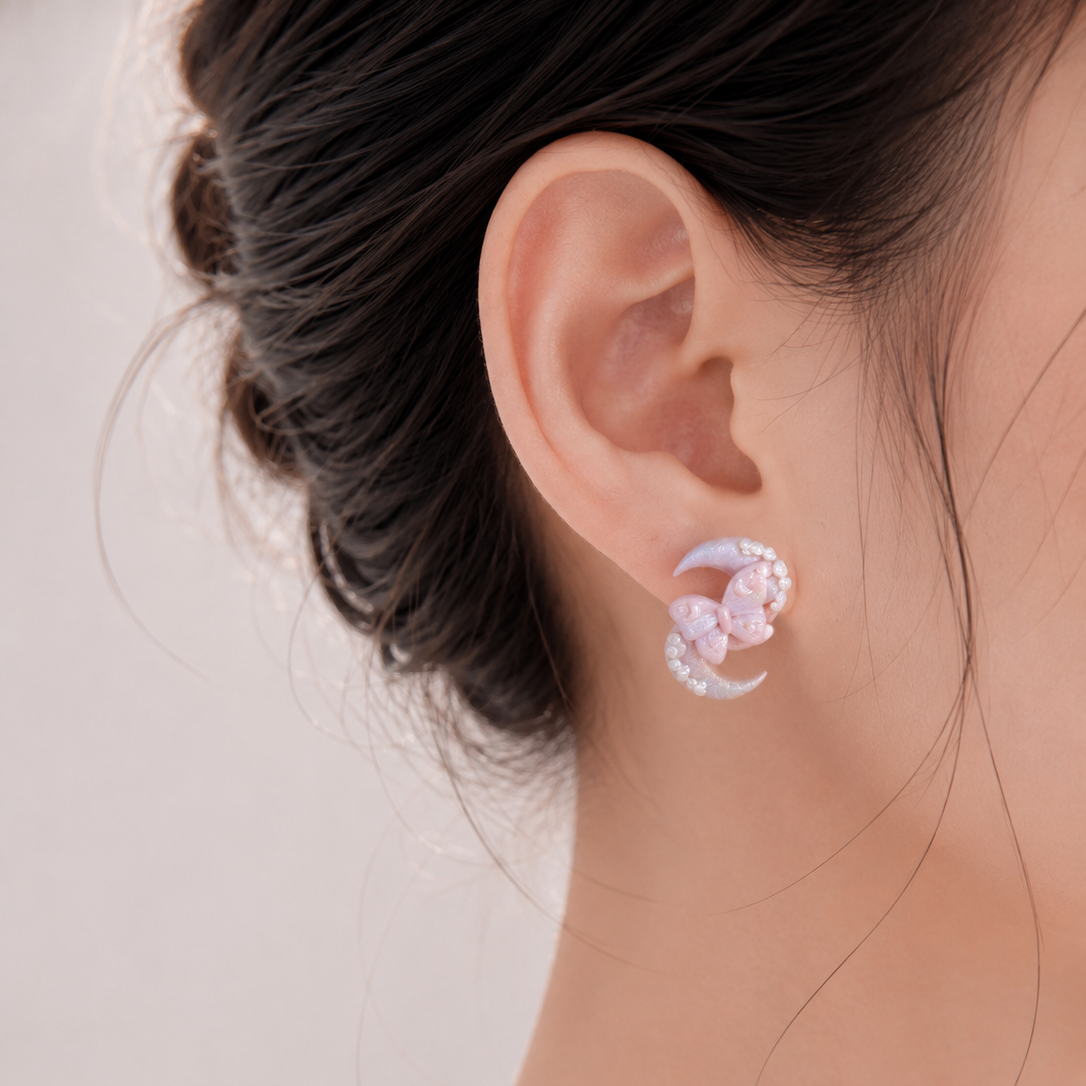 Close-up of an ear wearing a delicate earring with a soft background
