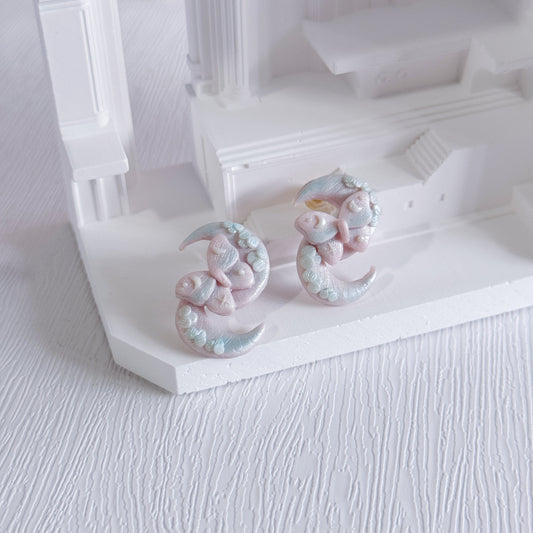 Decorative earrings on a white stand with a white background