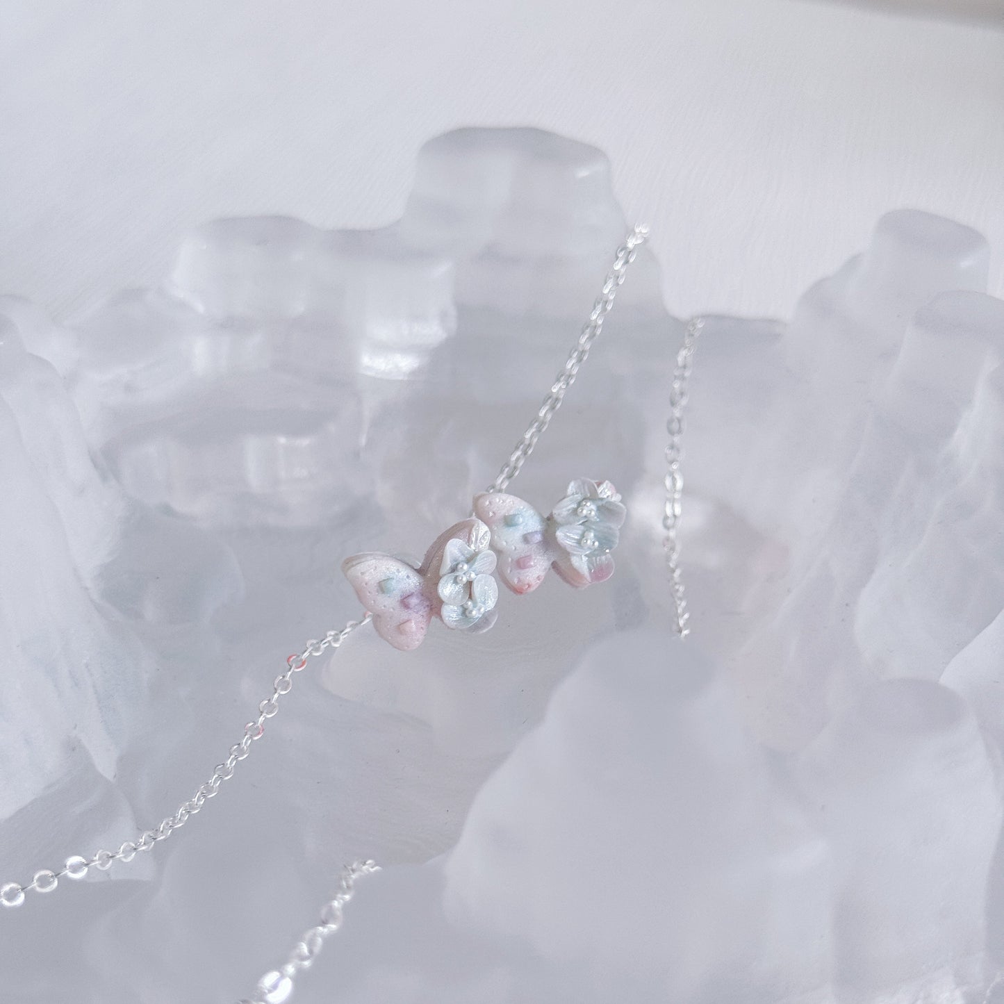 Butterfly-shaped earrings on a white background