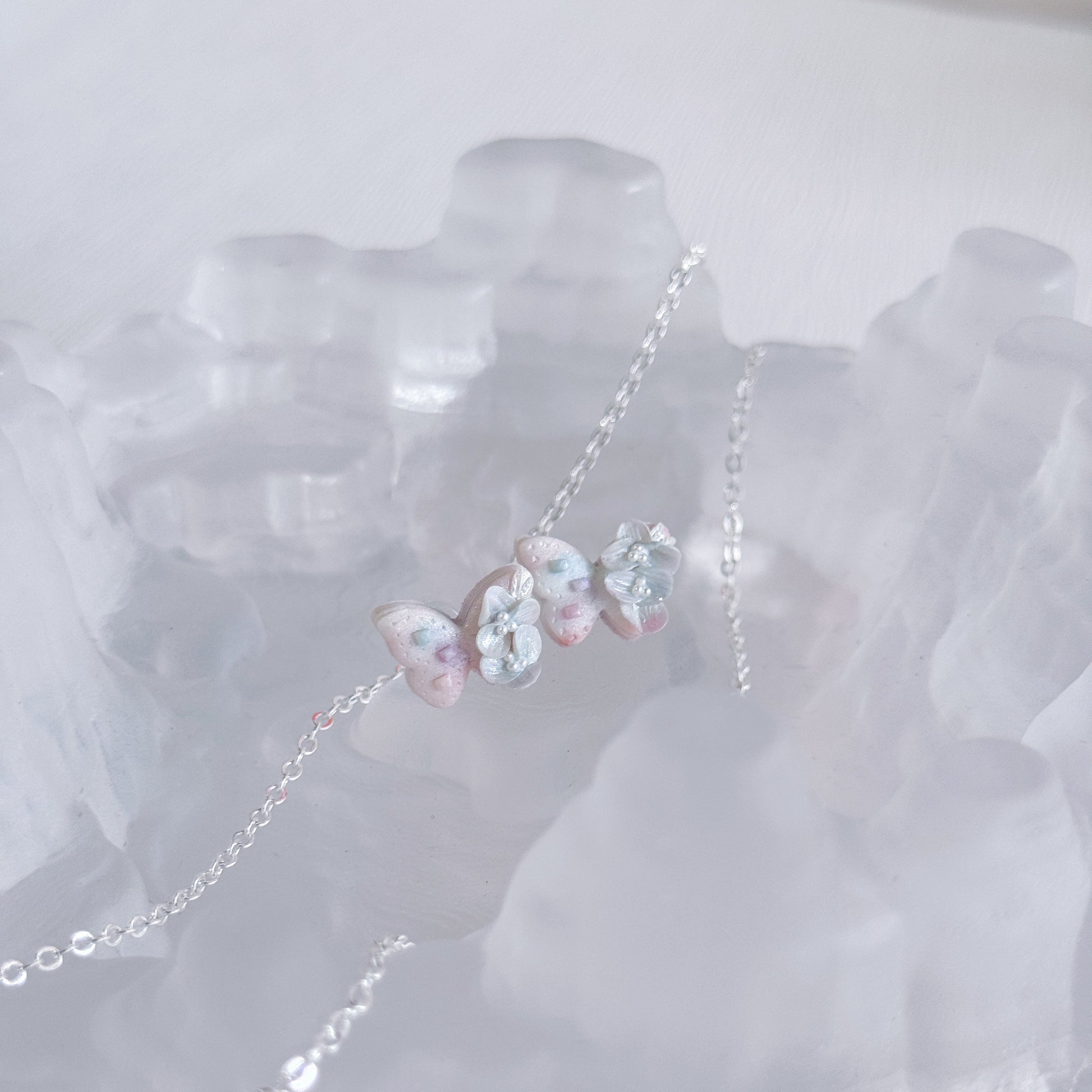 Butterfly-shaped earrings on a white background