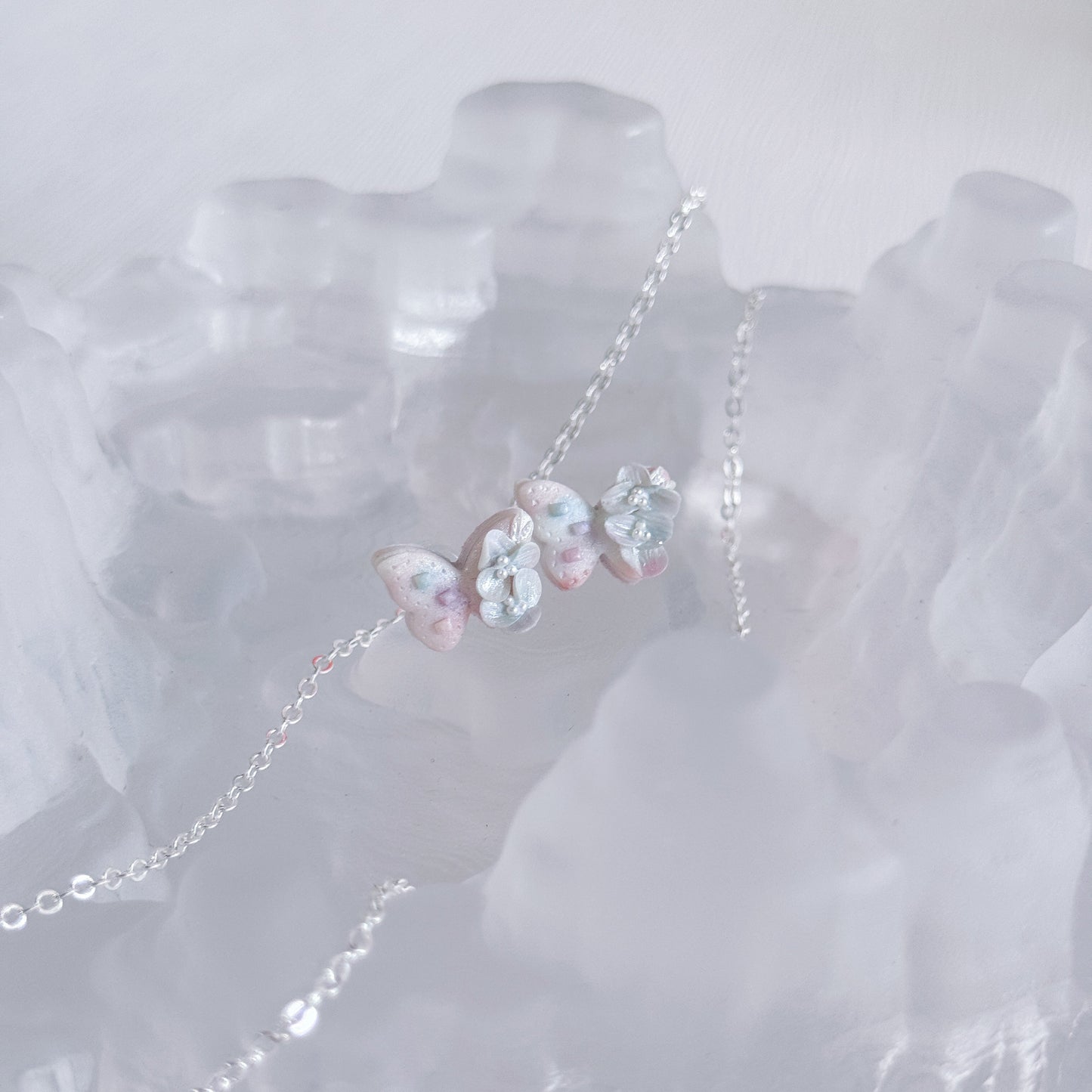 Butterfly-shaped earrings on a white background